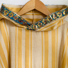 Load image into Gallery viewer, Upcycled from striped cotton blend remnant, super shiny and eclectic salvaged ribbon, and a cotton tee graphic tee. When I received this t-shirt I didn&#39;t know who Carmencita was - turns out she was a Spanish-style notable dancer from the late 1800s/early 1900s. Perhaps this poncho&#39;s story will add a little flavor to your dance vibes?!  Handcrafted with love and intention.  Upcycled poncho Carmencita dancing vibes One-of-a-kind Free size Handmade in Santa Cruz, CA Cold wash, hang dry
