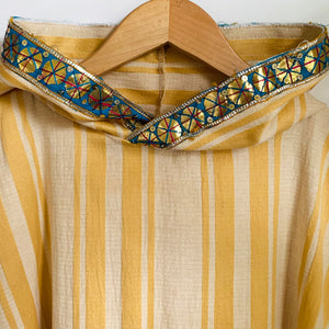 Upcycled from striped cotton blend remnant, super shiny and eclectic salvaged ribbon, and a cotton tee graphic tee. When I received this t-shirt I didn't know who Carmencita was - turns out she was a Spanish-style notable dancer from the late 1800s/early 1900s. Perhaps this poncho's story will add a little flavor to your dance vibes?!  Handcrafted with love and intention.  Upcycled poncho Carmencita dancing vibes One-of-a-kind Free size Handmade in Santa Cruz, CA Cold wash, hang dry