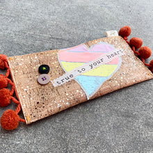 Load image into Gallery viewer, Upcycled from cork fabric cuts, salvaged dingle balls, buttons and zipper, scrap heart graphic tee and remnant message fabric. Super lightweight, thin and perfect for your essential ID and cards, and little love notes!  Cork fabric with zipper One-of-a-kind Sweet and whimsical Hand made in Santa Cruz, CA
