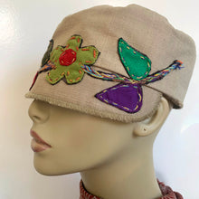 Load image into Gallery viewer, One of a kind design elements and embellishments upcycled from salvaged remnant fabric scraps, and hand sewn in Santa Cruz, CA. 100% cotton cap, handmade in Bali.   Floral embroidered embellishments Tan colored cap Flower power vibes 100% cotton US size 7 1/4&quot; *  Wash cold, hang dry *see size chart for detailed measurement
