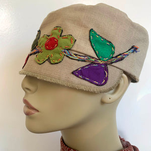 One of a kind design elements and embellishments upcycled from salvaged remnant fabric scraps, and hand sewn in Santa Cruz, CA. 100% cotton cap, handmade in Bali.   Floral embroidered embellishments Tan colored cap Flower power vibes 100% cotton US size 7 1/4" *  Wash cold, hang dry *see size chart for detailed measurement