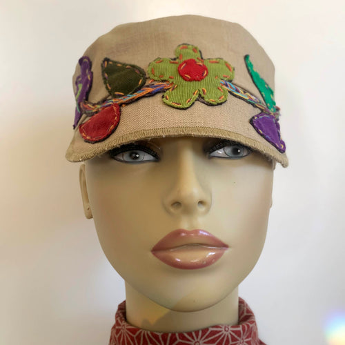 One of a kind design elements and embellishments upcycled from salvaged remnant fabric scraps, and hand sewn in Santa Cruz, CA. 100% cotton cap, handmade in Bali.   Floral embroidered embellishments Tan colored cap Flower power vibes 100% cotton US size 7 1/4
