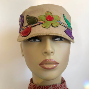 One of a kind design elements and embellishments upcycled from salvaged remnant fabric scraps, and hand sewn in Santa Cruz, CA. 100% cotton cap, handmade in Bali.   Floral embroidered embellishments Tan colored cap Flower power vibes 100% cotton US size 7 1/4" *  Wash cold, hang dry *see size chart for detailed measurement