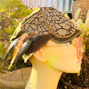 One of a kind, design elements and embellishments upcycled from salvaged remnant fabric scraps, and hand sewn in Santa Cruz, CA. 100% cotton cap, handmade in Bali.   Brown corduroy and "cracked playa" fabric   Army green colored cap Adorned with several different feathers  100% cotton US size 7 1/4" *  *see size chart for detailed measurement