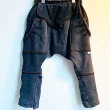 Load image into Gallery viewer, Upcycled from a well loved, and naturally distressed Prairie Underground organic cotton adult jacket, turned into these size 3-4T supa fly and cozy harem pants. Lots of detail and colorful stitching. This piece is sure to rock the playgrounds! Handcrafted with love and intention.  Handmade in Santa Cruz, CA One-of-a-kind Size 3-4T, skinny legs, super comfortable Front pockets for accent and special treasures Cold wash
