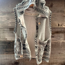 Load image into Gallery viewer, Upcycled entirely from an adult tribal print top (last pic, revealing what it started as so you can see its transformation). Another perfectly cozy layer of warmth for your little fearless heart!   Handcrafted with love and intention.   Upcycled and one-of-a-kind Button clasp, using trim cuts from the top for the string tie Pockets for treasures Oversized hoodie Handmade in Santa Cruz, CA Size 4/5 T Cold wash, hang dry
