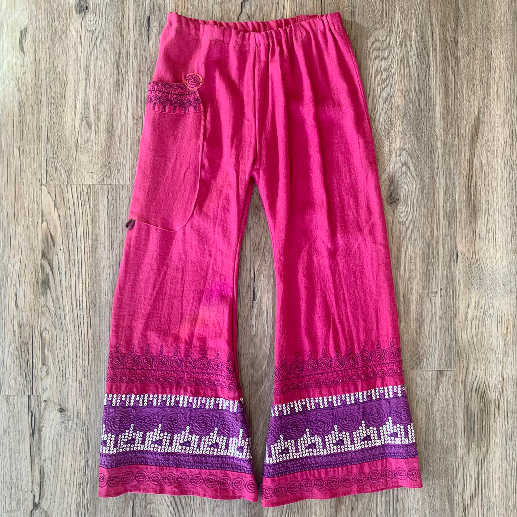 Upcycled from a Moroccan dress into flowy flare pants.   Handcrafted with love and intention.   Handmade in Santa Cruz, CA One-of-a-kind Linen, cotton blend fabric with silver sequins  Eastern vibes, detailed embellishments Big pocket for magical finds  Size 8-10 youth 