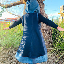 Load image into Gallery viewer, Upcycled from several stretch denim adult clothing pieces, and a cut out of one of our limited hand screen printed conscious message tees: sovereign BEing! Super comfortable, extremely soft and flowy, with a hood for that extra layer of cozy. Arm holes are intentionally larger so dress can be worn for bigger sizes as a shorter dress.    Handcrafted with love and intention.   Upcycled sleeveless dress One-of-a-kind True essence vibes Handmade in Santa Cruz, CA
