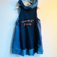 Load image into Gallery viewer, Upcycled from several stretch denim adult clothing pieces, and a cut out of one of our limited hand screen printed conscious message tees: sovereign BEing! Super comfortable, extremely soft and flowy, with a hood for that extra layer of cozy. Arm holes are intentionally larger so dress can be worn for bigger sizes as a shorter dress.    Handcrafted with love and intention.   Upcycled sleeveless dress One-of-a-kind True essence vibes Handmade in Santa Cruz, CA
