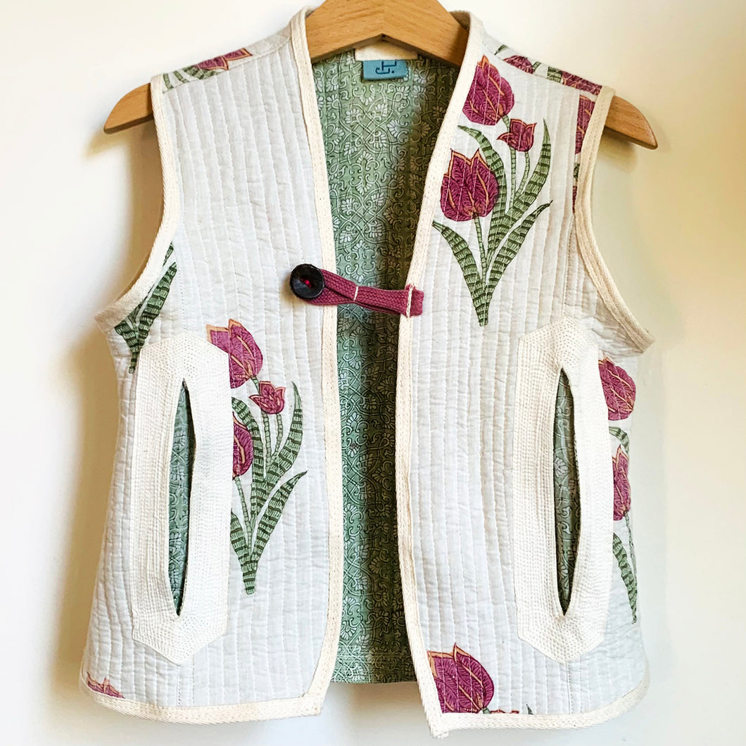Upcycled from a quilted cotton adult jacket, now this super sweet and playful vest for an extra layer of flair and warmth.   Handcrafted with love and intention.   Upcycled and one-of-a-kind Leather vintage button, cord clasp Light and whimsical layer of love Handmade in Santa Cruz, CA Size 4-5T Spring vibes Cold wash, hang dry