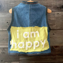 Load image into Gallery viewer, Upcycled from jeans, graphic tee, and salvaged embellishments. Lined with cotton tee. This cute vest is the perfect layer of warmth and love.   Handcrafted with love and intention.   Upcycled and one-of-a-kind Handmade in Santa Cruz, CA Size 2-3T I AM HAPPY 
