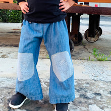 Load image into Gallery viewer, Upcycled from a super soft jean skirt, with stitched knee patches. This piece is so fun and whimsical, time to wear your flare!  Handcrafted with love and intention.  One-of-a-kind Size 4-5T, wide legs Flowy and super comfortable Handmade in Santa Cruz, CA
