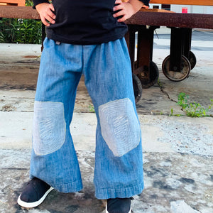 Upcycled from a super soft jean skirt, with stitched knee patches. This piece is so fun and whimsical, time to wear your flare!  Handcrafted with love and intention.  One-of-a-kind Size 4-5T, wide legs Flowy and super comfortable Handmade in Santa Cruz, CA