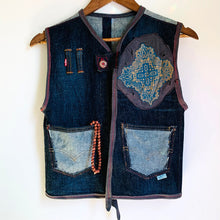 Load image into Gallery viewer, Upcycled from 100% cotton Levis 511 adult jeans and cuts from an Om Gaia Tree tribal print top. Intentional distress, revealed stitching, reversed pockets for a unique, super fresh and whimsical detail.   * Mala beads not included. xoxo  Button clasp One-of-a-kind Size 8-10 youth Handmade in Santa Cruz, CA Cold wash
